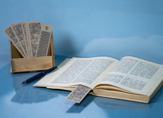 Line-art bookmarks standing in a wooden box
