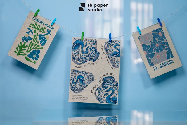 Three printed flyers in blue and green ink pegged on a line