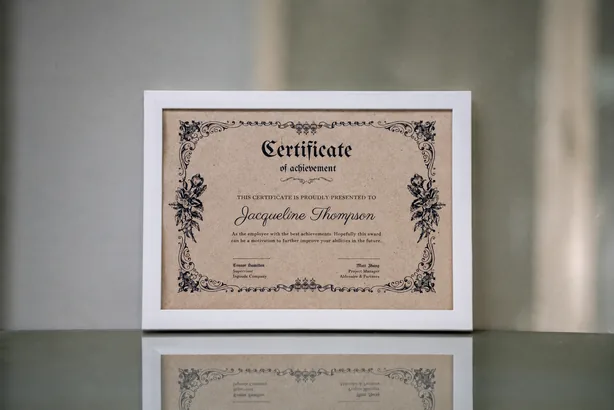 A framed certificate of achievement with an ornamental border