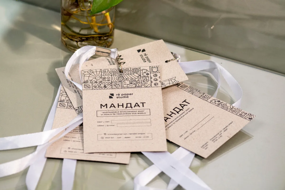 Event badges (mandat) on white ribbons, printed on seeded paper