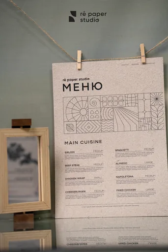 An A4 menu printed in black ink, pegged on a line