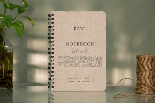 A spiral-bound A5 notebook with a printed recycled-paper cover