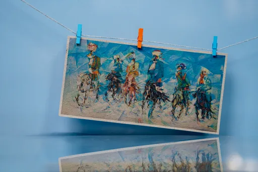 An A3 print of a horse-race painting pegged on a line